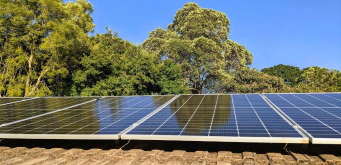 Rooftop solar panels against a clear blue sky in Hillcrest