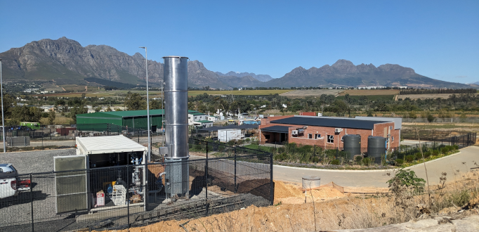 Containerised high-temperature flare plant at Stellenbosch Landfill with mountains behind